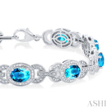 7x5 MM Oval Shape Blue Topaz and 1/10 ctw Round Cut Diamond Semi Precious Bracelet in Sterling Silver